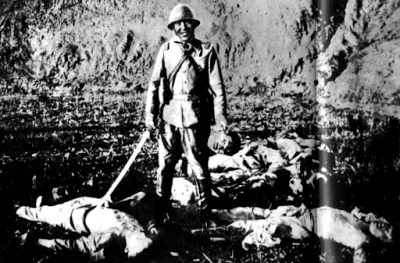 A Japanese Soldier Grins While Holding Up The Severed Head Of His Victim. Nanking Massacre, December 1937 – January 1938.
