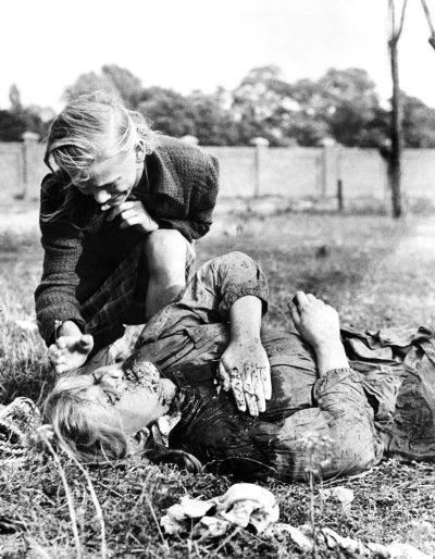 Polish 12-year-old Girl Kneeling Over The Body Of Her Sister Who Was Killed During Bombing By The Nazis, Poland On September 9, 1939.